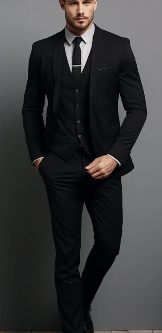 Man wearing a black suit with a white shirt and tie on a gray background