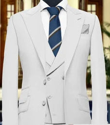 White suit jacket with a blue tie on a mannequin against a blurred indoor background