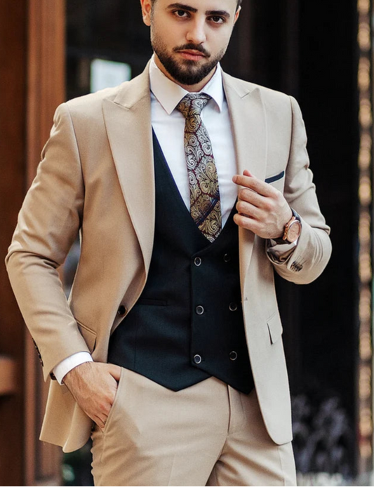 Man wearing a beige suit with a patterned tie in an urban setting