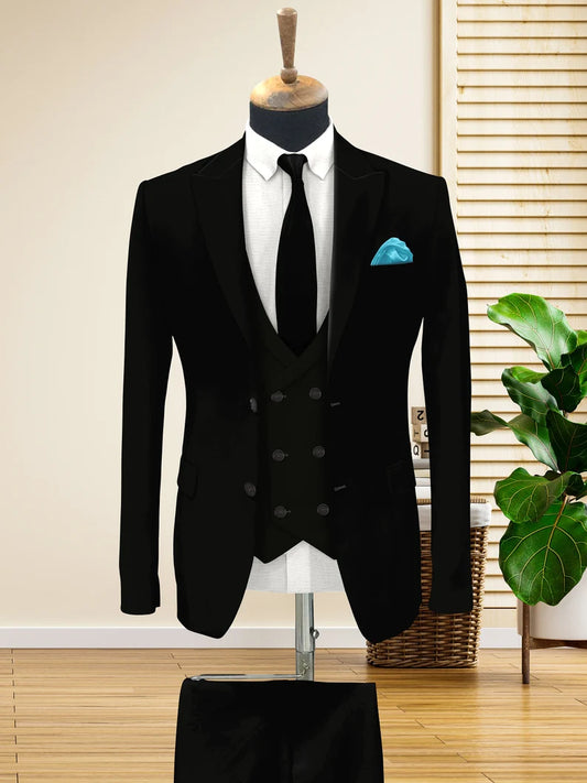Black suit on a mannequin with a white shirt and blue pocket square, against a neutral background.